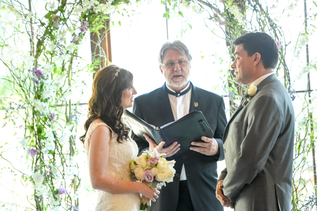 A photo of a couple saying "I do" to the wedding vows