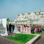 A photo of Andrew Allen officiating a wedding near the Pacific Ocean at The Ritz Carlton, Half Moon Bay