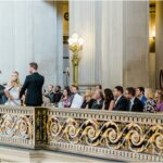 A photo of Andrew Allen officiating a wedding on the mayor's balcony San Francisco City Hall