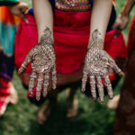 A photo of a bride shows off her Hands with Henna Mehndi for Wedding