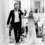 A photo of a couple Celebrating on the Mayor's Balcony in San Francisco City Hall