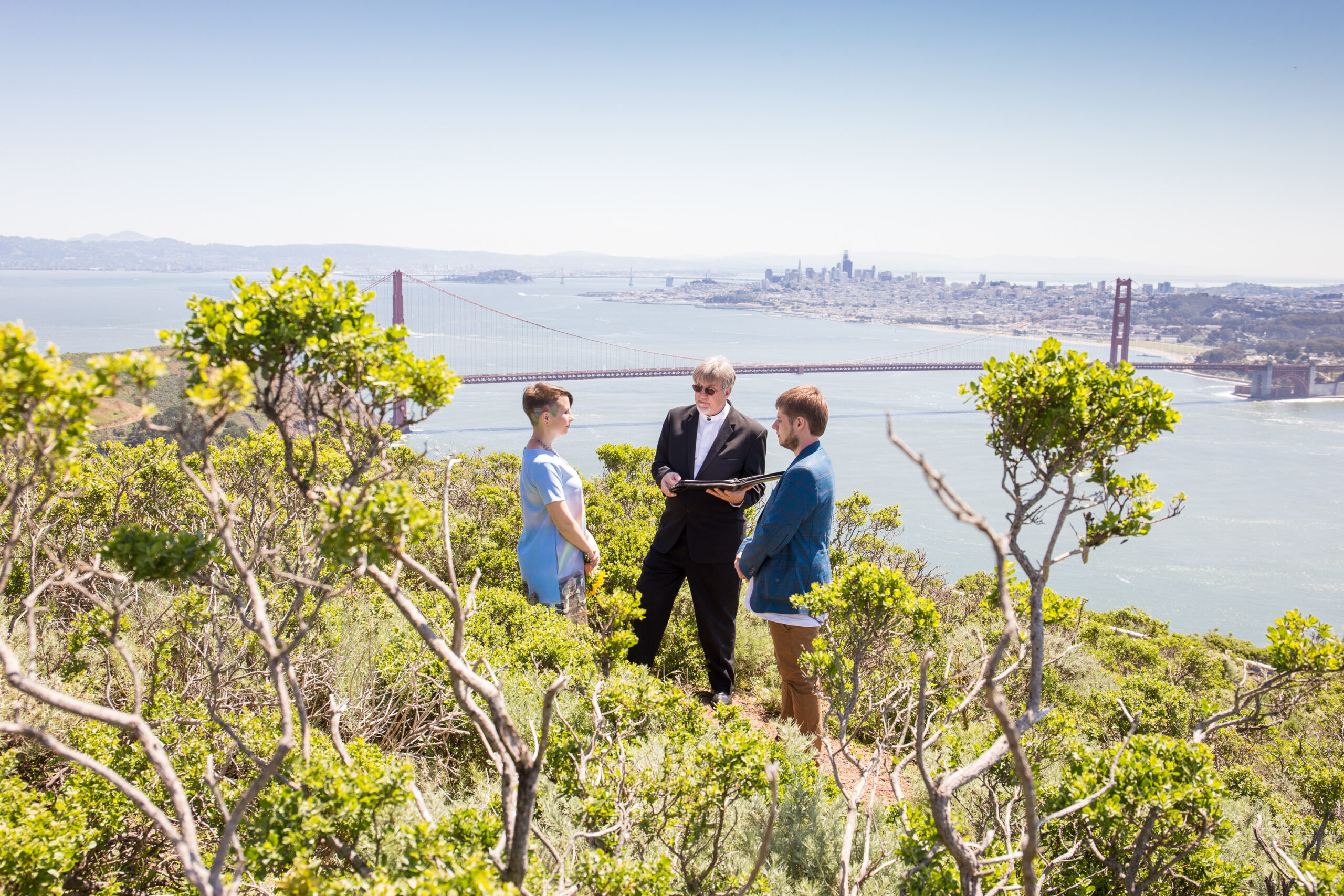 Young couple wedding ceremony overlooking the Golden Gate bridge near San Francisco CA