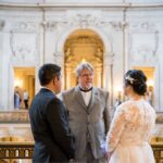 A happy couple getting married on the Mayor's Balcony at San Francisco City Hall