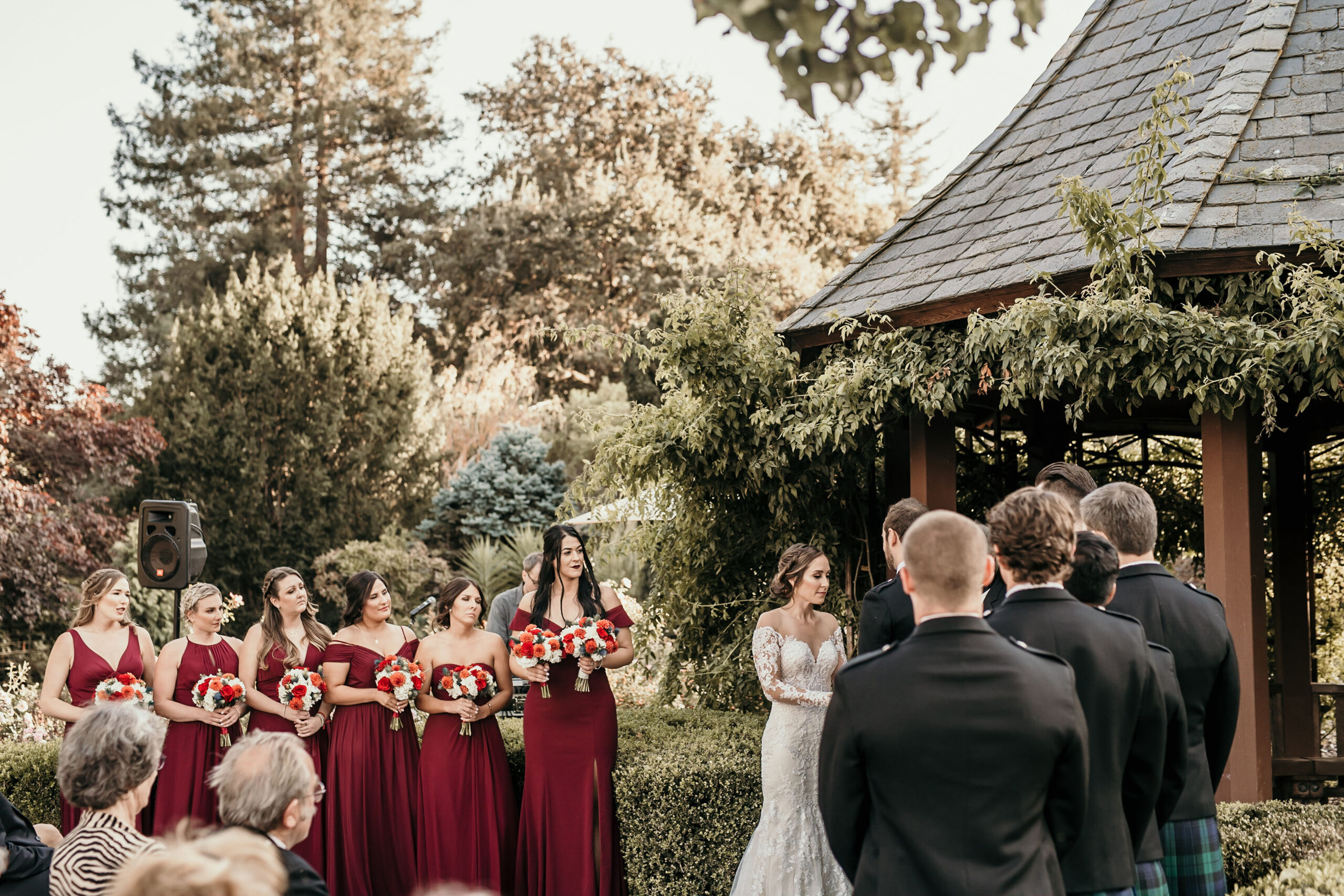 Brides, Maids and Groomsmen all lined up during a wedding cermony.